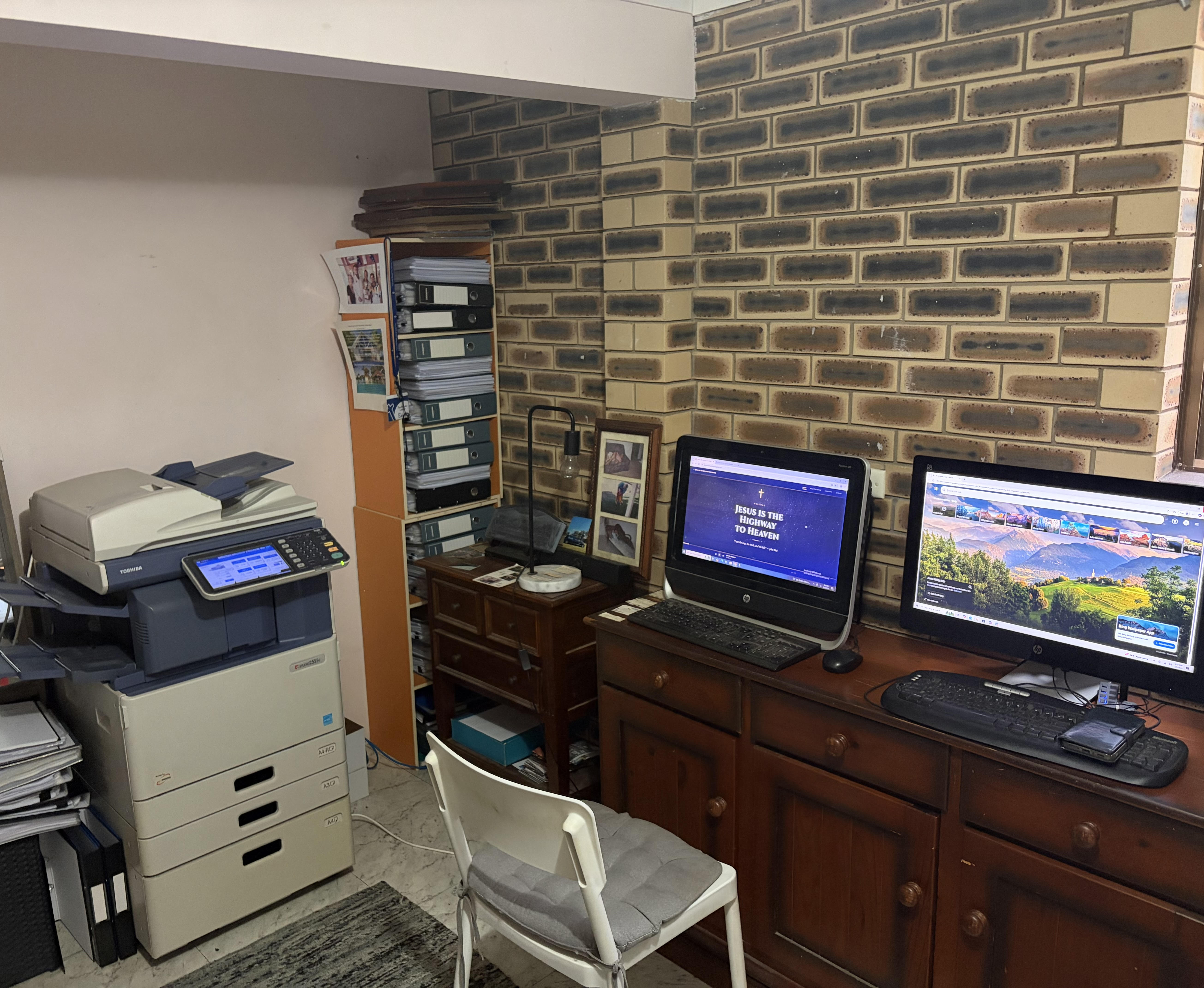 God's Engine Room — Ed's workspace with two computers and photocopier